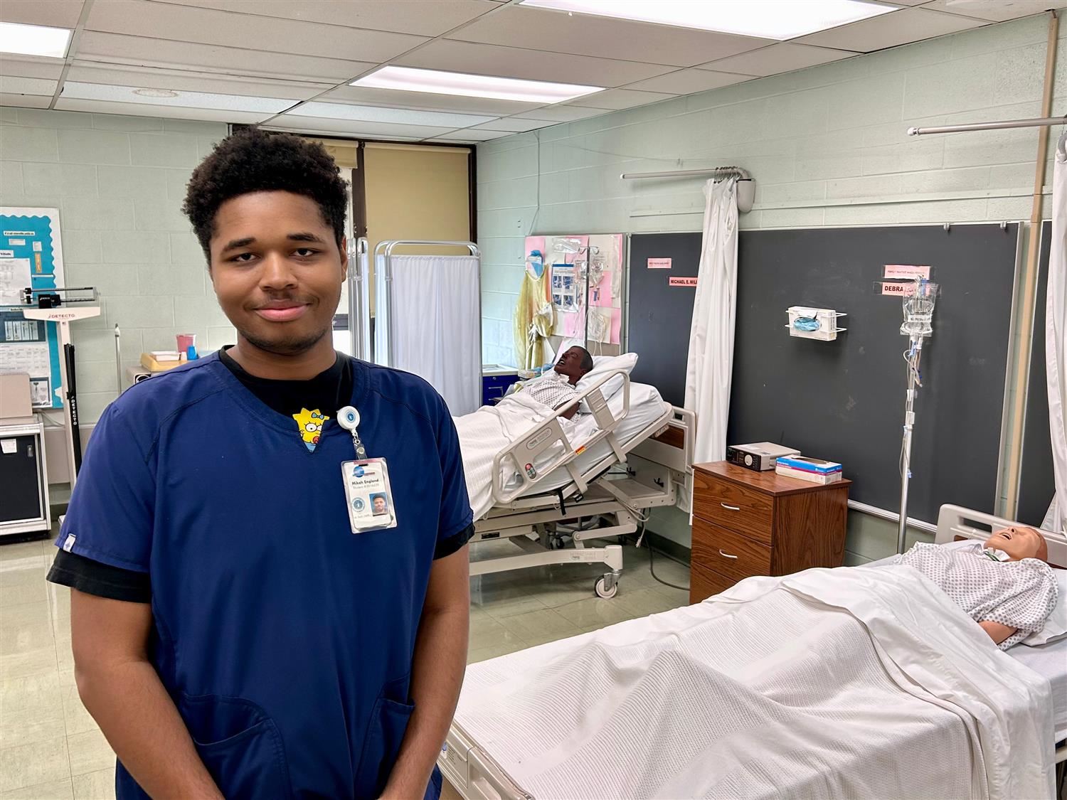 student standing in a simulated hospital room